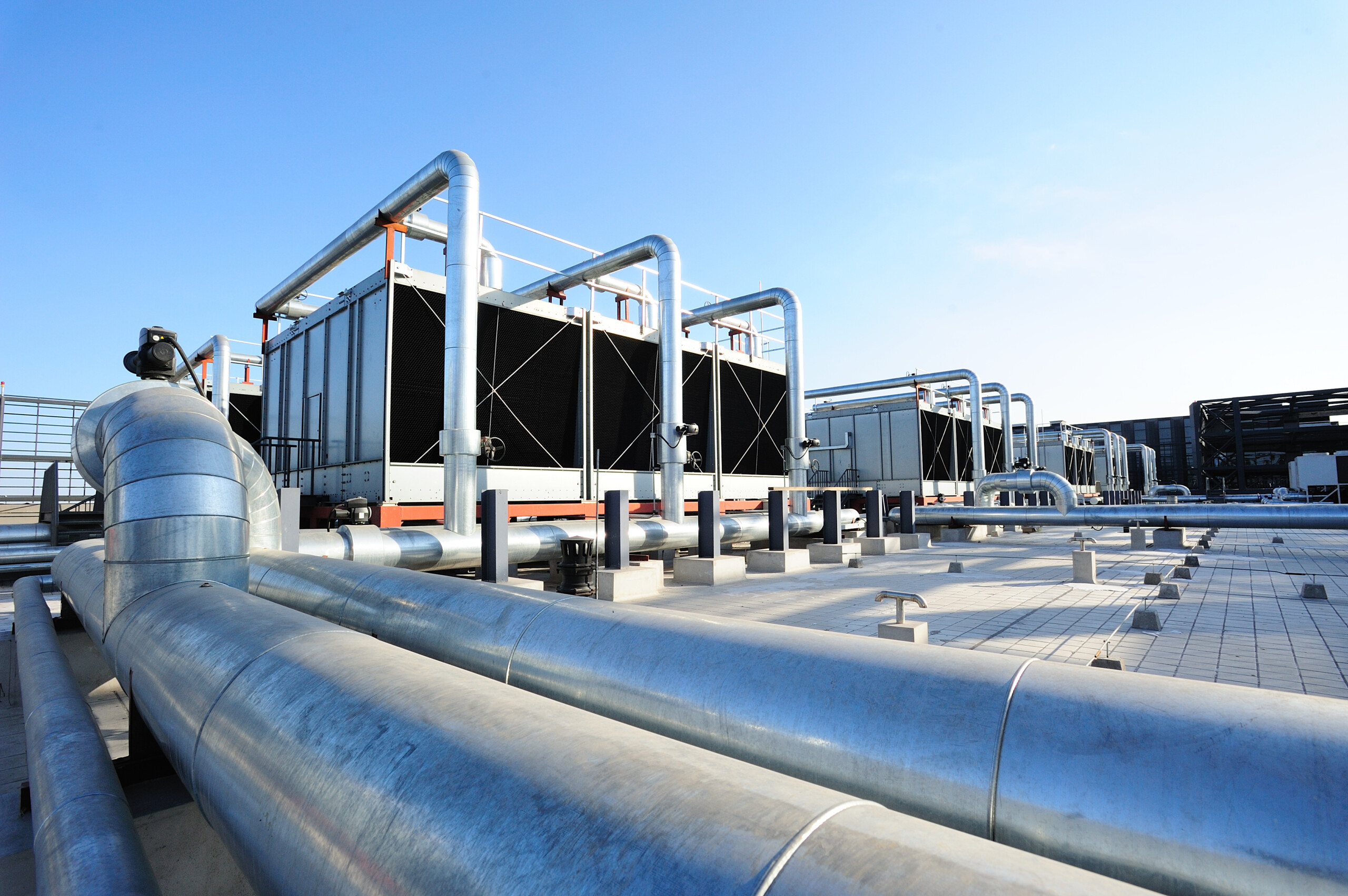 Rooftop industrial cooling towers and metal pipes